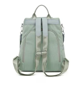 Detail view of the light green corduroy backpack back with adjustable shoulder straps