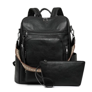 Close-up of black lychee grain leather backpack set with jacquard woven strap and hardware