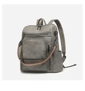 Grey PU leather backpack detail with ethnic weave strap and stylish tassel accent