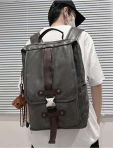 Detail of dark grey PU leather backpack with contrast brown accents and teddy bear charm
