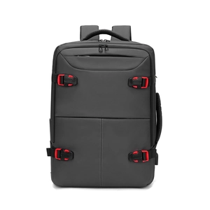 Business travel backpack in dark grey with red accent buckles and multi-handle design