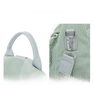 Detail view of the mint green corduroy backpack with leather handle and metal D-ring buckle