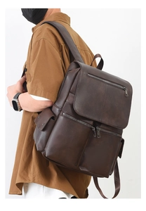 Side view of men's dark brown leather backpack with multiple zip pockets and荔枝 texture