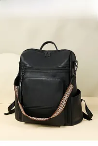Close-up of black PU leather backpack with a colorful geometric patterned strap