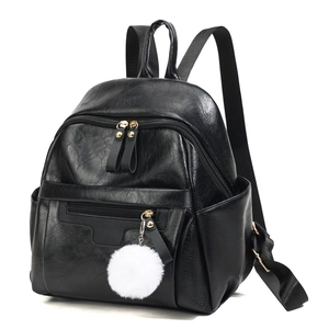 Black PU leather backpack with lychee texture and a plush ball charm for women