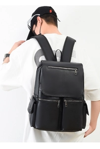 Detail of black matte business backpack showing spacious compartments and zippers