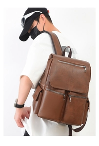 Side view of model wearing a vintage brown faux leather backpack for daily commute
