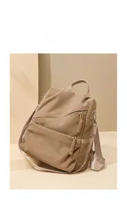 Detail of khaki corduroy travel backpack with leather handle and adjustable nylon strap