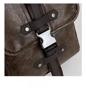 Close-up of premium metal buckle and textured brown PU leather on vintage backpack