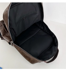 Detail view of large capacity dark brown PU leather backpack with internal zipper pocket