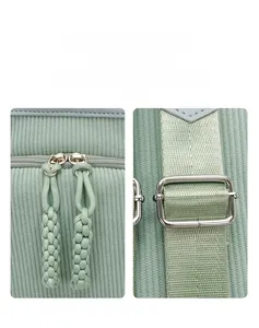 Detail view of mint green corduroy backpack with dual zippers and adjustable metal buckle