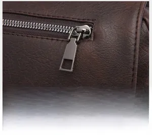 Macro shot of durable gunmetal zipper on dark brown lychee textured leather backpack