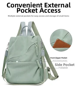 Detail view of the green corduroy backpack front pocket showing storage capacity