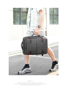 Business travel backpack in dark grey with red buckle detail for outdoor commuting