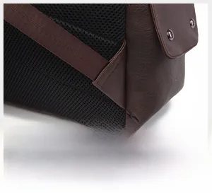 Detail of reinforced triangle stitching and breathable mesh on a brown leather backpack