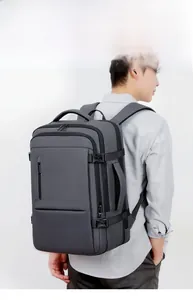 Detail view of dark grey business backpack showing side handle and waterproof fabric