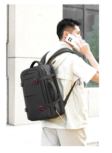 Detail of multi-compartment business backpack showing external USB charging port in use