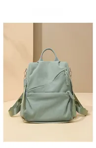 Detail of light green corduroy backpack with textured fabric and woven zipper pull