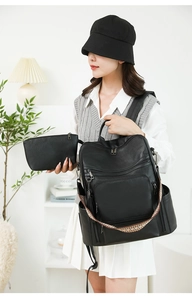 Close-up of black PU leather backpack and matching zipper clutch bag with woven strap