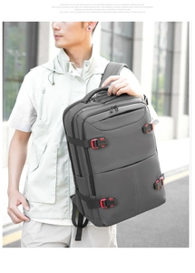 Detail of grey water-resistant business backpack with red buckles in an outdoor setting
