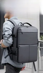 Men's large travel backpack for business trips shown in a modern outdoor urban setting