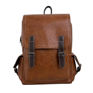 Vintage brown PU leather backpack with buckle straps and contrast stitching on white background