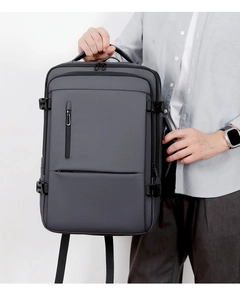 Detail of dark grey travel backpack showing water-resistant fabric and side buckle