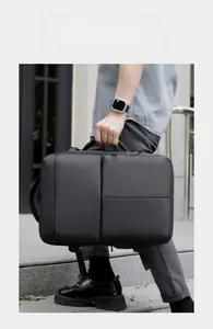Detail view of a black water-resistant laptop backpack with versatile carrying handles