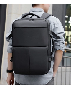 Outdoor back view of a men's large black business travel backpack with waterproof fabric