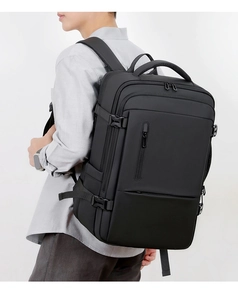 Side view of black business travel backpack with matte waterproof fabric on model