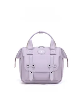 Front view of a purple Oxford fabric diaper bag with top handles and circular logo