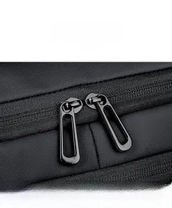 Macro shot of smooth metal double zippers and textured black fabric on travel backpack