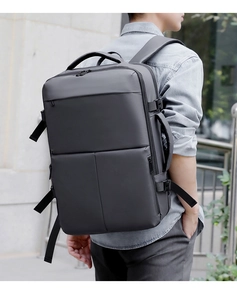 Detail view of large grey business travel backpack with side handle and waterproof fabric