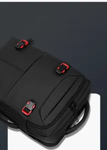Close-up of black business backpack with red buckle and water-resistant nylon texture