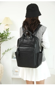 Fashionable black PU leather backpack with large capacity and decorative zipper tassel