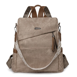 Bruine canvas anti-diefstal rugzak voor dames met geweven riem en kwastje als detail