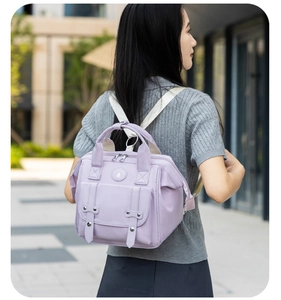 Close-up of light purple mommy bag showing durable nylon texture and magnetic front pocket