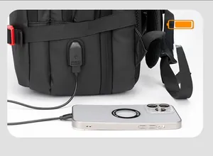 Detail of integrated USB charging port on a black professional business backpack