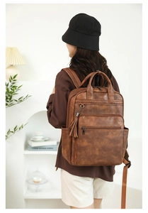 Brown PU leather backpack with vintage texture and stylish tassel zipper detail