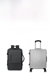 Expandable black business travel backpack compared with a silver suitcase for size reference