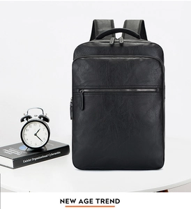 Detailed view of black faux leather business backpack with litchi texture and front pocket