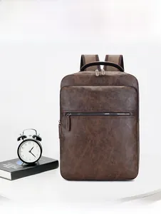 Detail of dark brown leather backpack with lychee texture and secure zipper pockets