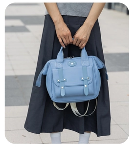Detail of light blue mommy bag with waterproof nylon texture and front buckle pocket