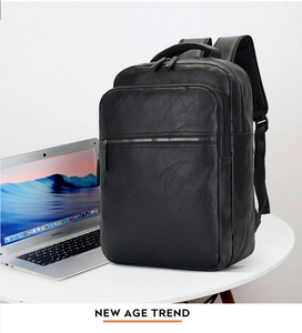 Detail view of the black PU leather backpack showing fine texture and functional zippers