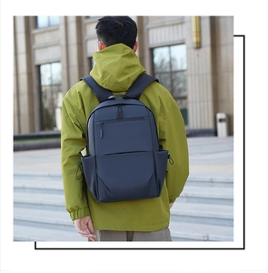 Outdoor macro shot of deep blue waterproof business backpack featuring drawstring side pockets