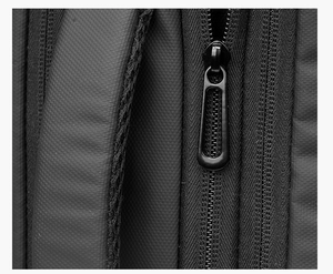 Detailed macro view of premium black metal zipper and breathable mesh strap on business backpack