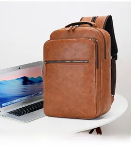 Detailed view of brown PU leather backpack featuring multiple zip pockets and laptop compartment