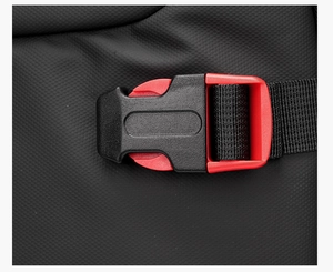 Detail of red and black buckle on textured black business backpack with nylon webbing strap