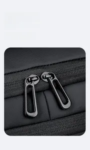 Detail of premium black double-way metal zippers on a travel laptop backpack