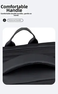 Detail of dual reinforced top handles and high-density waterproof fabric on black laptop bag